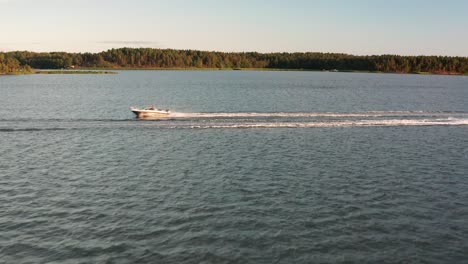 high speed boat chase from perpendicular angle - contrast between the archipelago, the sea and the two motorboats