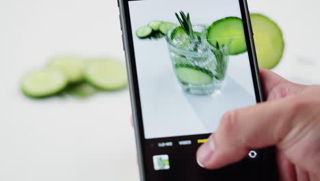 cucumber water cocktail photographed with a phone
