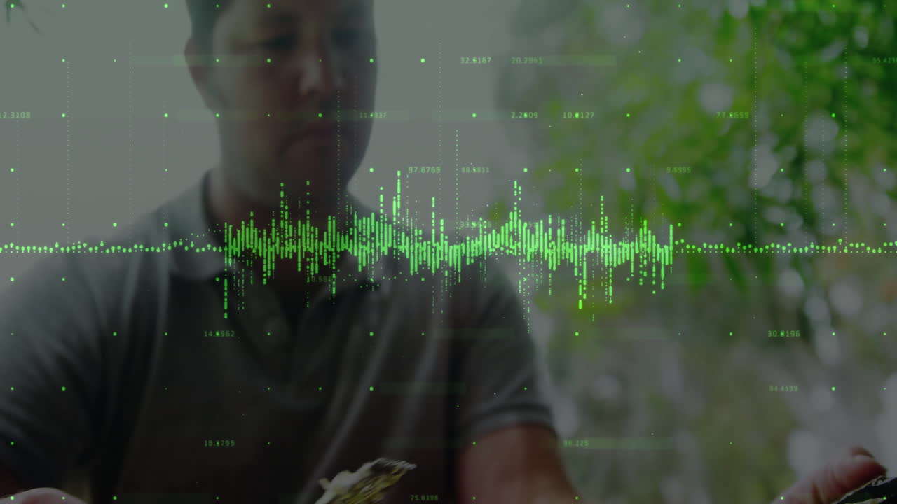 Adult man tapping device indoors with digital waveform floating across technology interface