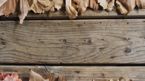 Close-up-view-of-autumn-leaves-with-copy-space-on-wooden-surface