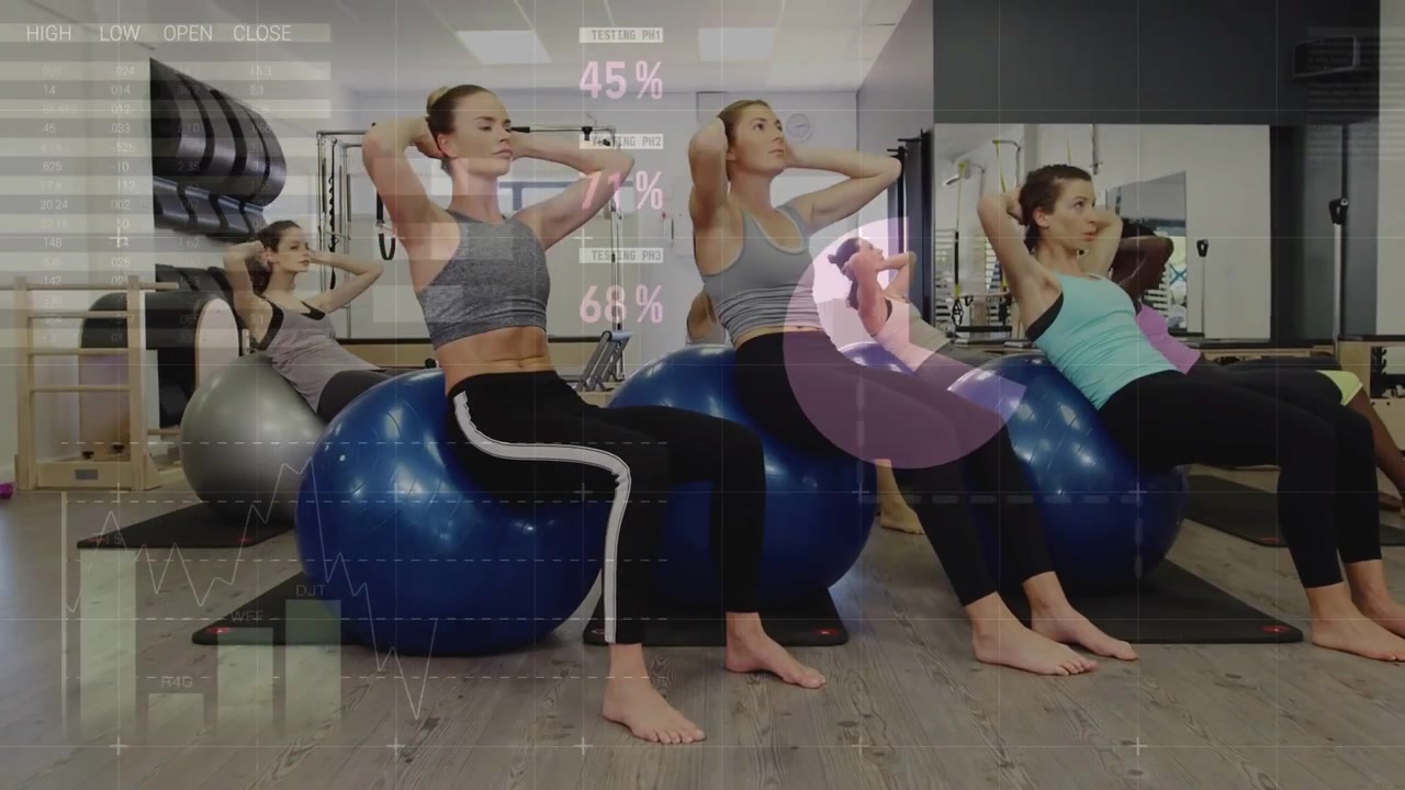 Five women on cue, performing crunches on fitness balls while faint charts displaying fitness data