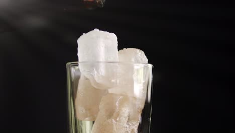 a showcase of the rotation cola with ice close up for a very large glass of cold with slow motion rotating