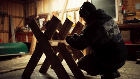 a man is crafting a sawbuck in indre fosen, trondelag county, norway - close up