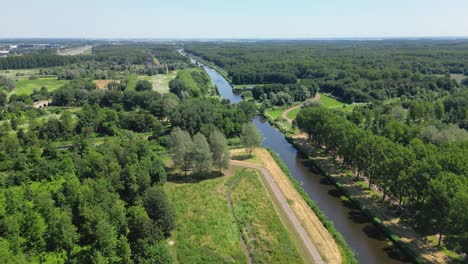 Aerial-drone-shot-above-a-nature-park,-water-canal,-abandoned-kastel-of-Almere-city,-province-Flevoland,-Netherlands