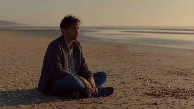 A man sitting on a beach