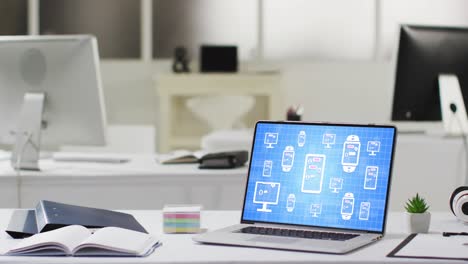 laptop with data processing on screen on office desk