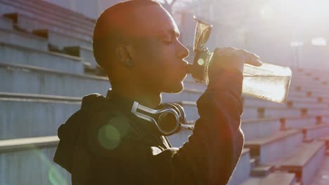 Disabled athletic drinking water at sports venue 4k