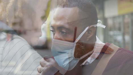 composite video of african american man wearing face mask against boy studying at school