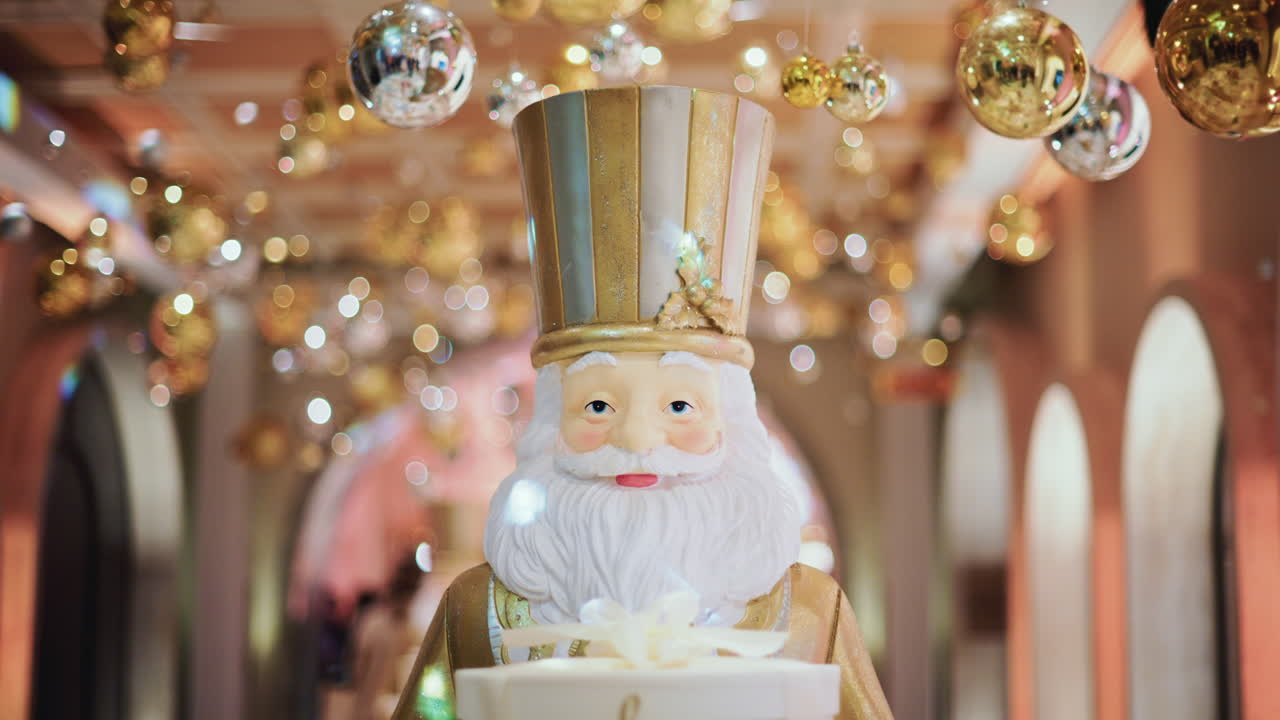 Close up of a Santa Claus figure inside a festive Christmas installation with warm lights and ornaments