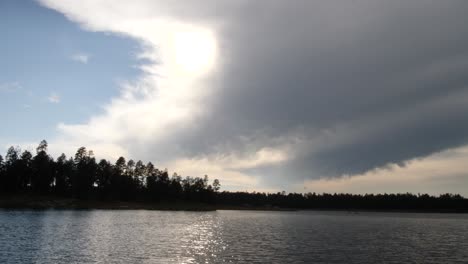 Clouds-partially-covering-the-sky-as-the-forest-is-silhouetted-against-the-sky