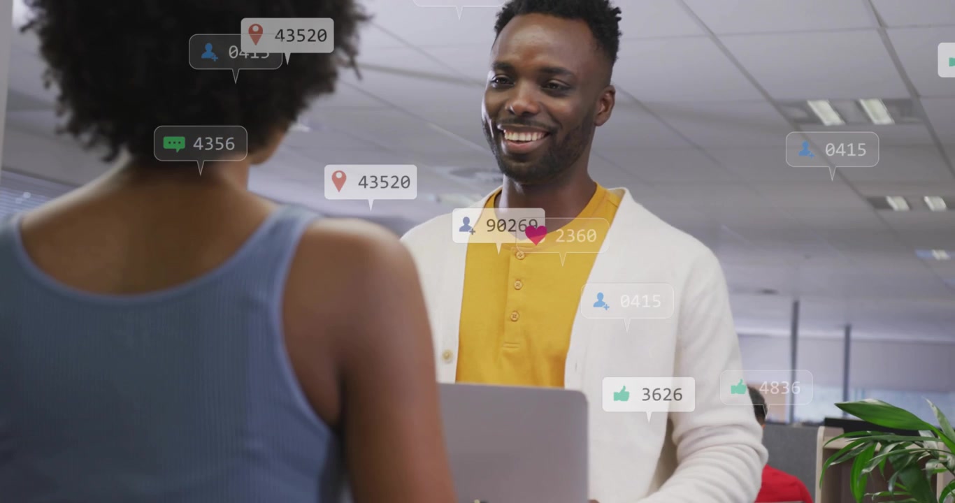 Man presenting laptop for marketing, notification icons rising then easing, woman noting