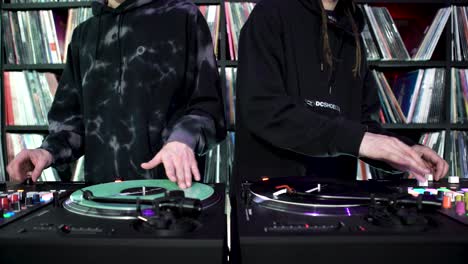 two djs mixing music on turntables