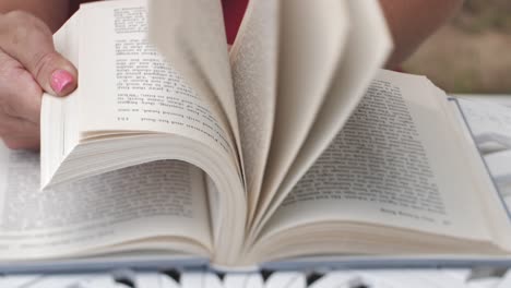Woman&#039;s hands flipping through a book