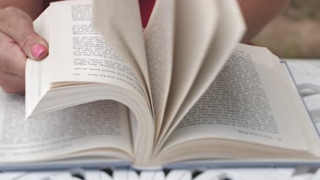 woman's hands flipping through a book