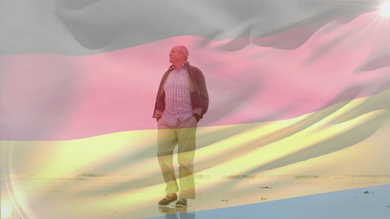 animación de la bandera de alemania sobre el hombre caucásico senior con las manos en el bolsillo caminando por la playa