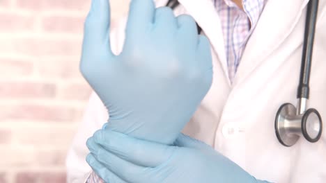 doctor putting on medical gloves