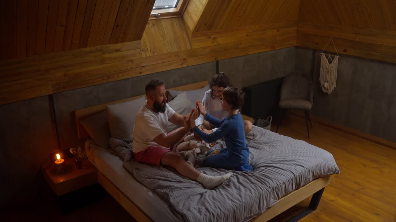 Family playing together on bed