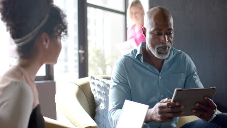 business african american man reviews documents in an office setting