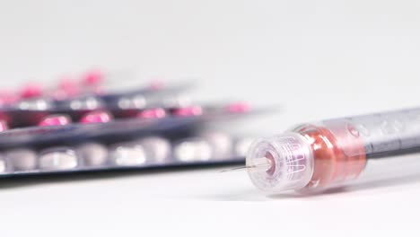 close-up of insulin pen and pills