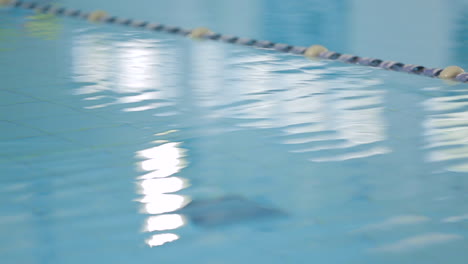 a static shot of water ripples in an indoor pool