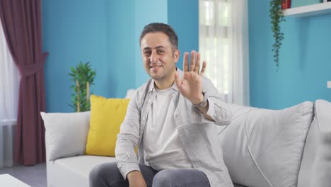 Happy-man-waving-at-camera.