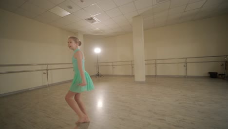 a group of young ballet students in black dancewear practicing positions in a spacious ballet studio with wooden flooring and wall-mounted barres. focused expressions and synchronized movements.