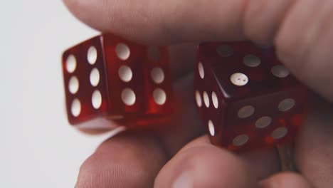 man-holds-plastic-dice-with-white-spots-on-palm-macro