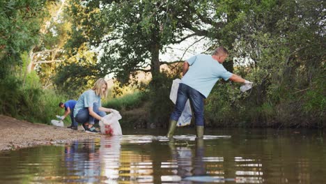 people cleaning the river in a forest