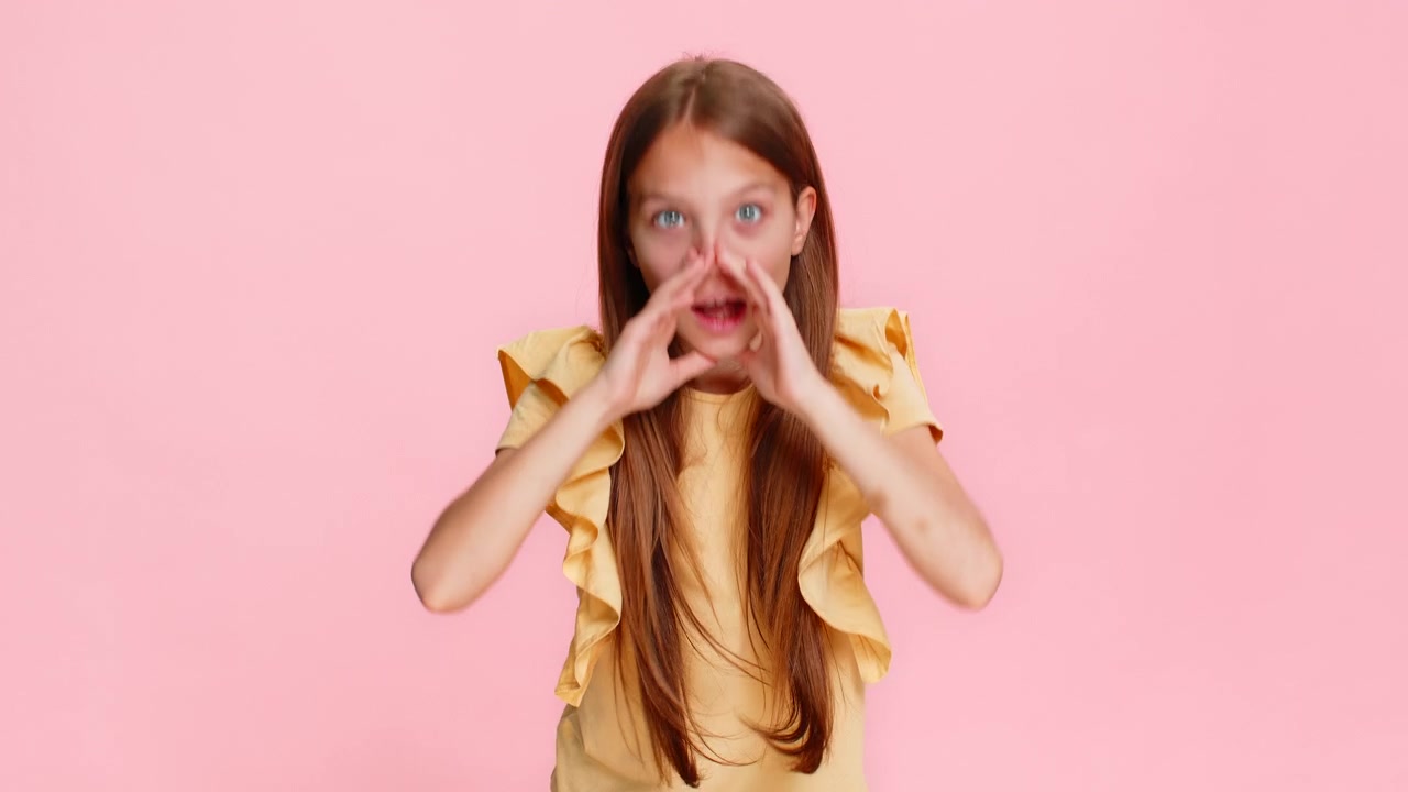 Child girl kid screaming with hands around mouth pretending to use loudspeaker call someone loudly