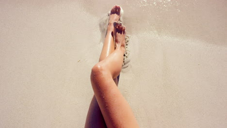 woman relaxing on beach with pineapple