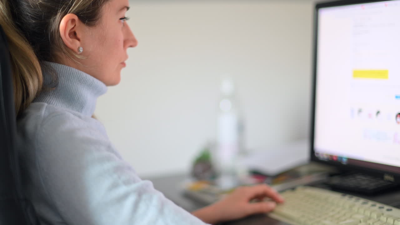 Woman designer working on stationary computer at the office