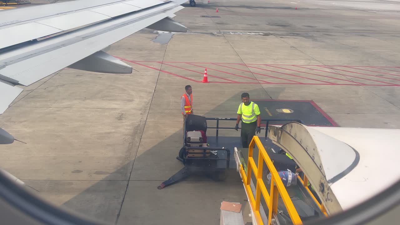 Airport Ground Crew Loading Luggage onto an Airplane