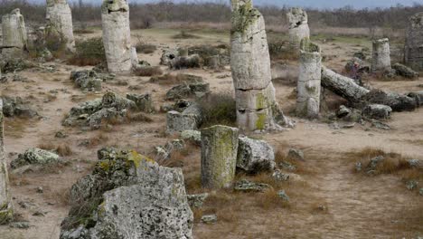 Woman-sits-on-stone-in-calm-peaceful-ancient-rock-formations-of-Pobiti-Kamani