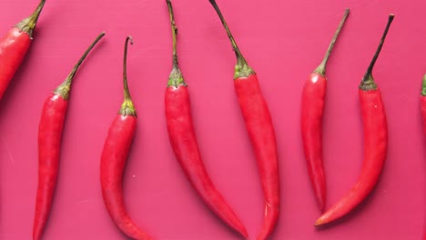 red chili peppers on pink background