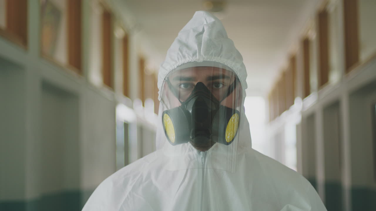 Person in Hazmat Suit in Hospital Corridor