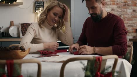 adult couple making christmas decoration at the table