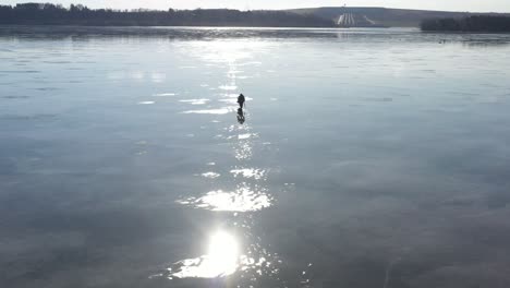 man walking on tiny ice in spring