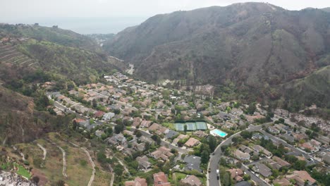 Wide aerial panning shot of Palisades Highlands after the wildfire in Pacific Palisades, California. 4K