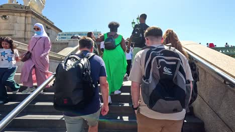 crowd walking up stairs in sunny london