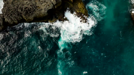 Ocean-waves-crashing-on-rocky-coast,-tropical-marine-landscape