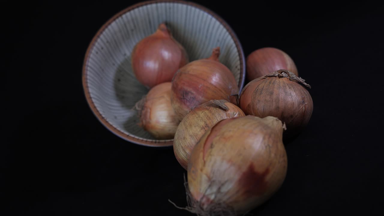 Onions spilling from a bowl - slide left