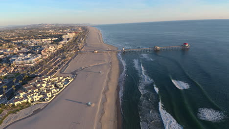 A 4K aerial drone timelapse of a beautiful sunset with the ocean on one side and the cityscape on the other and a pier straight ahead.