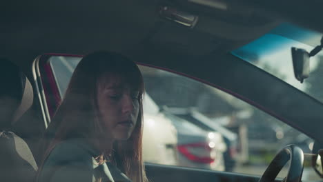 upset woman in green jacket opens door getting in red car