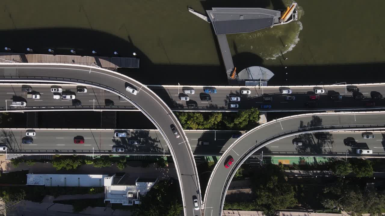 The network of intertwining roads and overpasses of the Riverside expressway built next to the Brisbane River. Aerial view