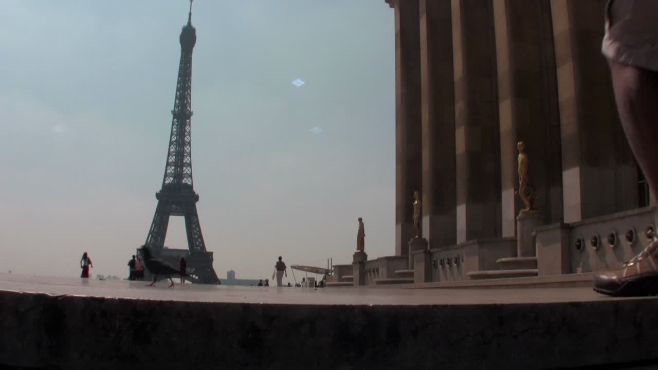 Tourists walk towards the Eiffel Tower in paris