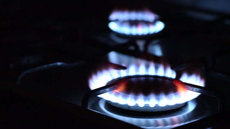 Gas igniting on the stove in the kitchen in the dark