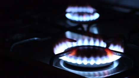 gas igniting on the stove in the kitchen in the dark