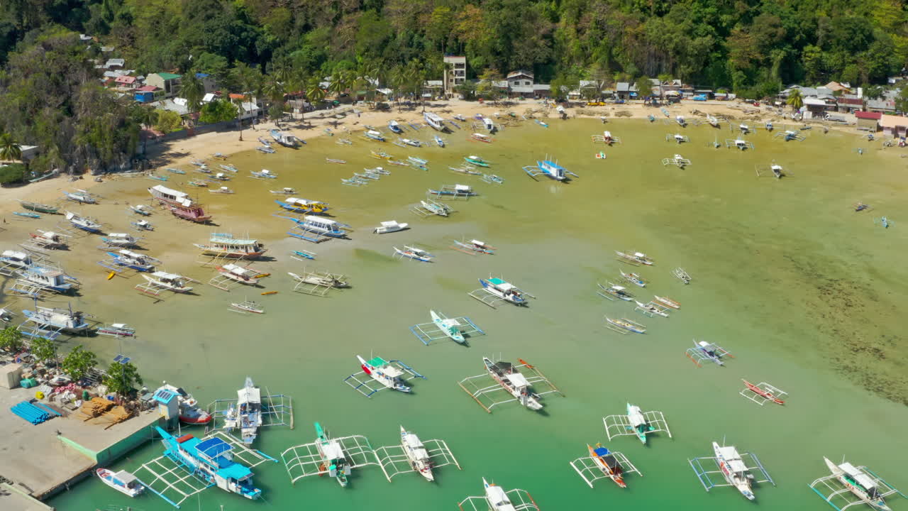 Aerial view of Bacuit Bay in El Nido, Palawan, Philippines with many traditional outrigger boats