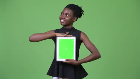 young beautiful african businesswoman showing digital tablet