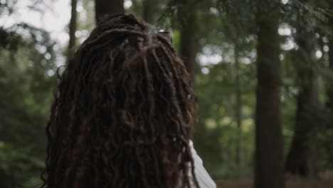 Close-up-of-young-adult-black-woman-with-glasses-looking-around-and-taking-in-the-beauty-of-nature-in-northern-michigan